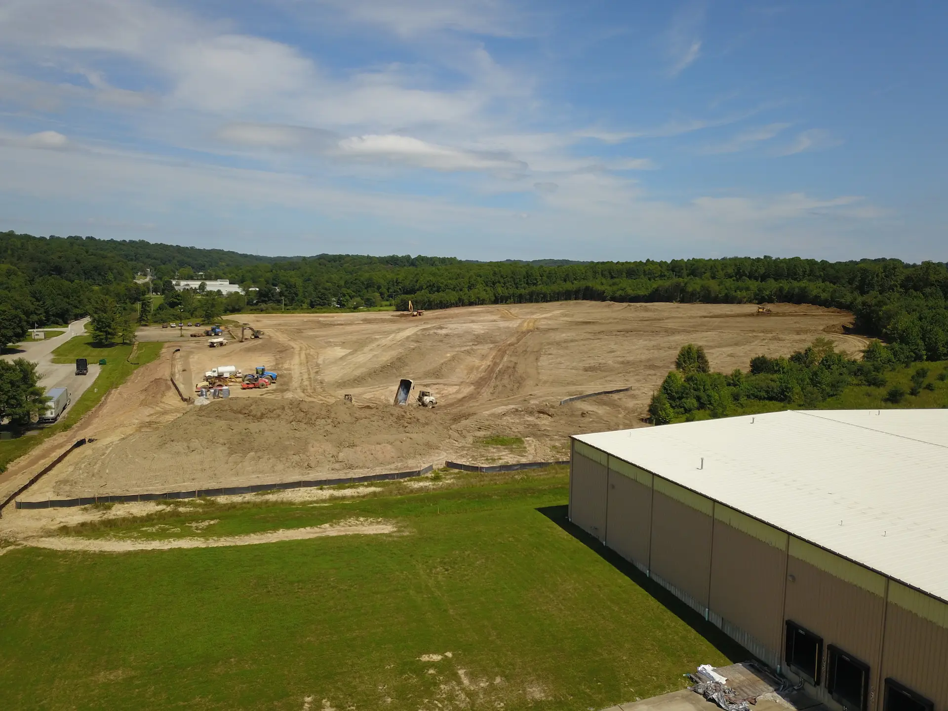 Civil work for a new warehouse with a recently completed one in the foreground