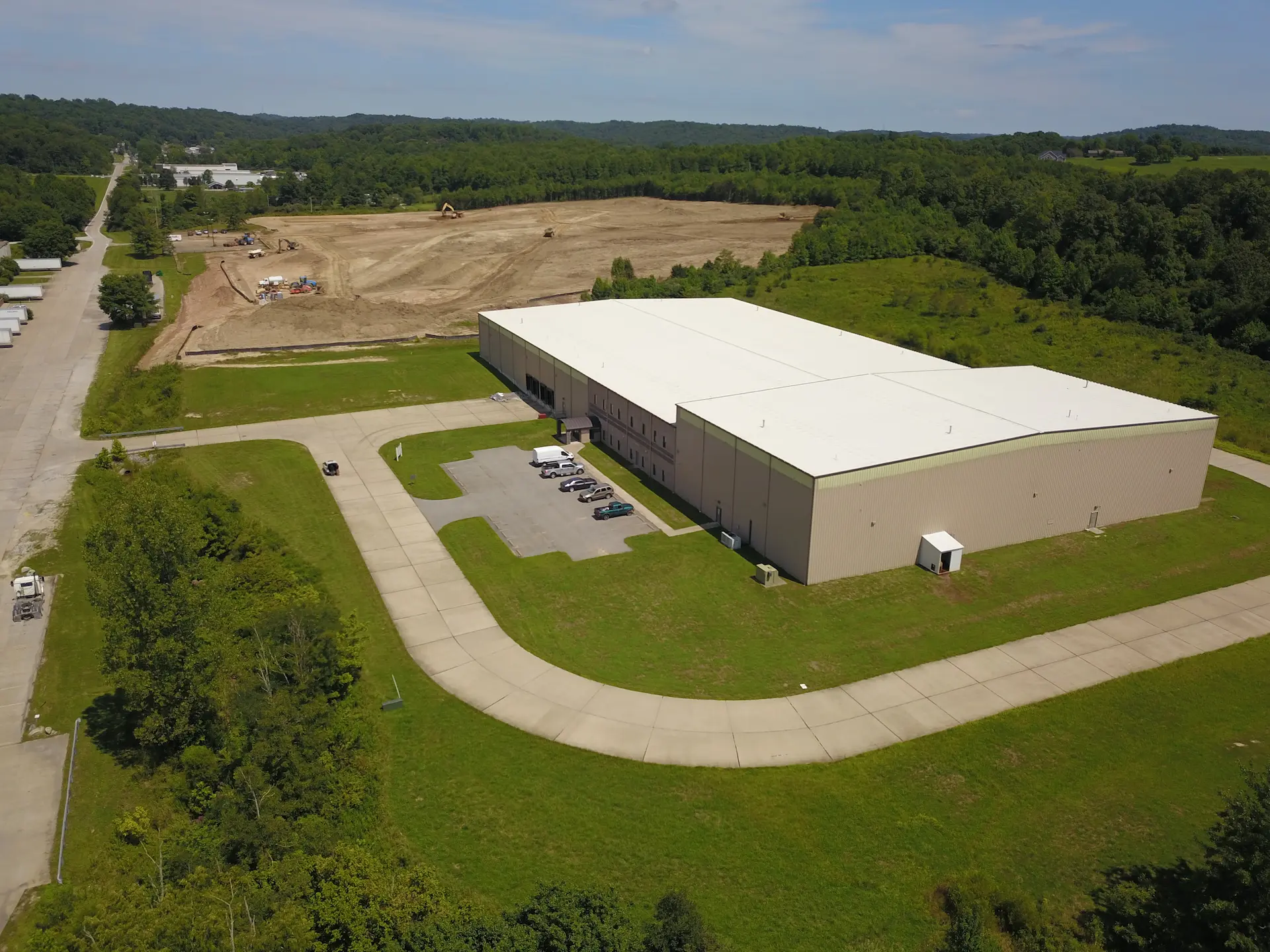 Completed warehouse with additional site prep being done in the background.