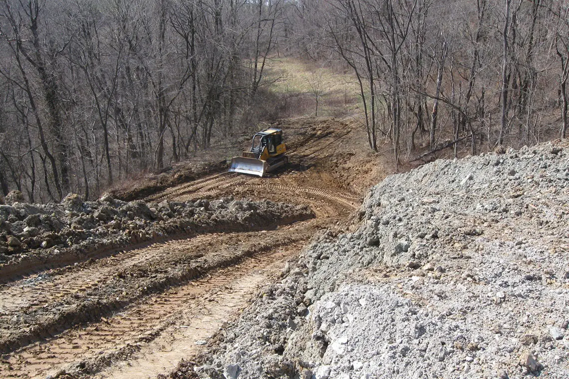 Soil being moved and bench cuts created.